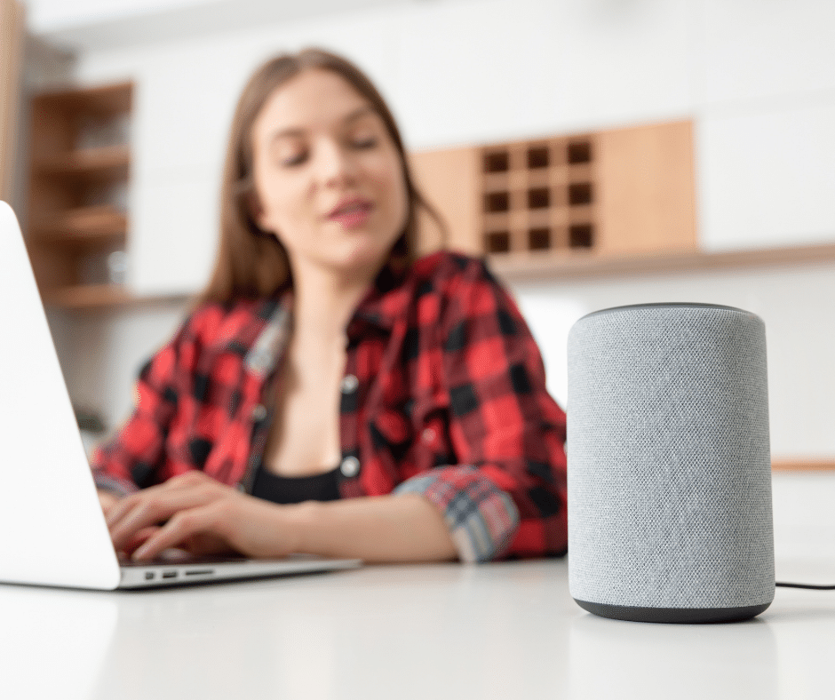 A person on a computer talking to an amazon echo