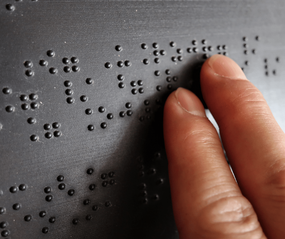 fingers touching braille