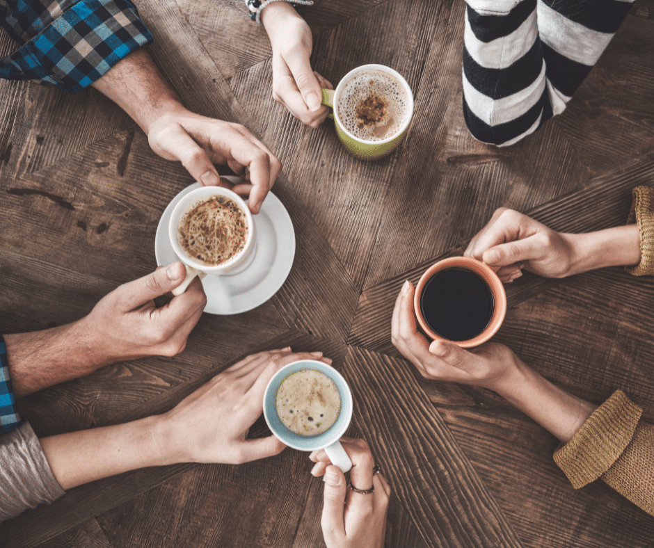 A top down view looking at people drinking coffee at a table