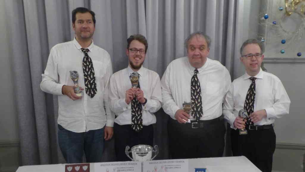 A photo of Alex, Paul, Danny, and Kevin posing with their trophies