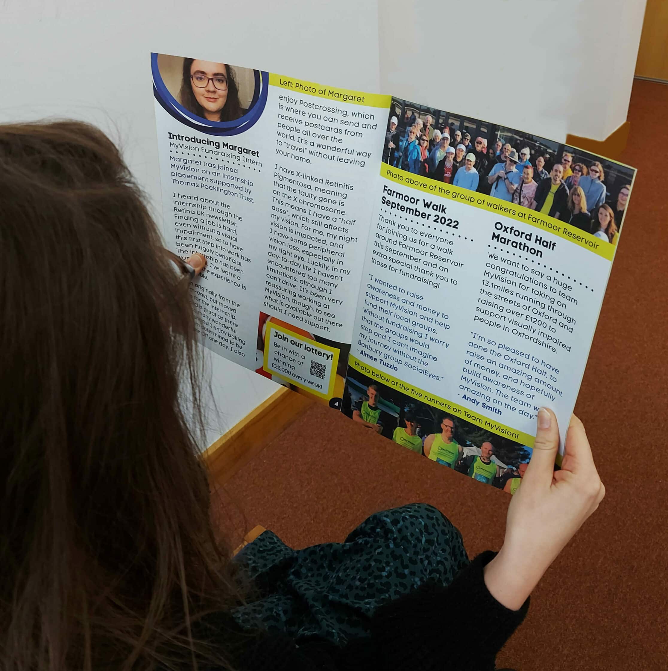 hands holding a newsletter