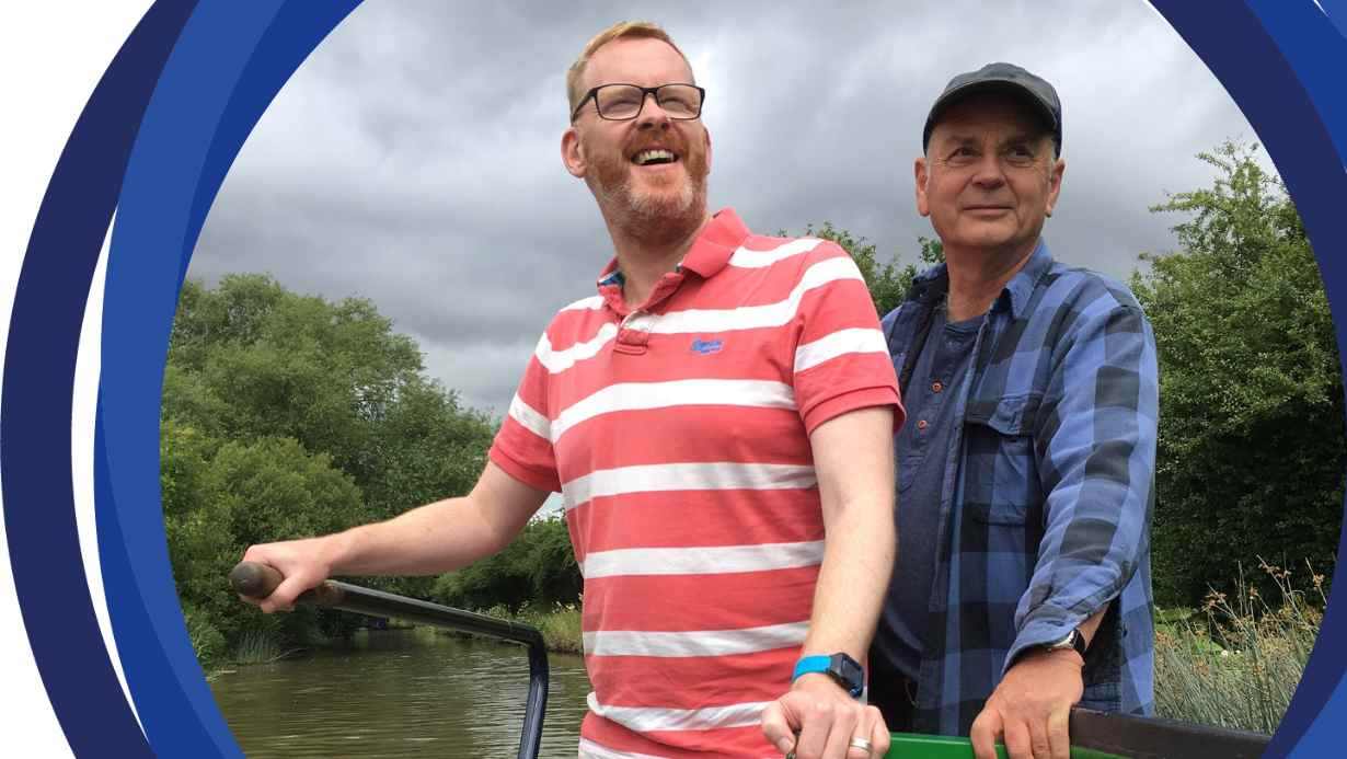 Andy (left) steering a boat