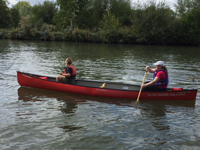 2 people in a canoe, paddling on the Thames