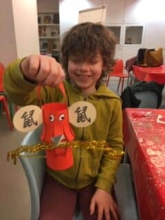 A boy holding a handmade lantern