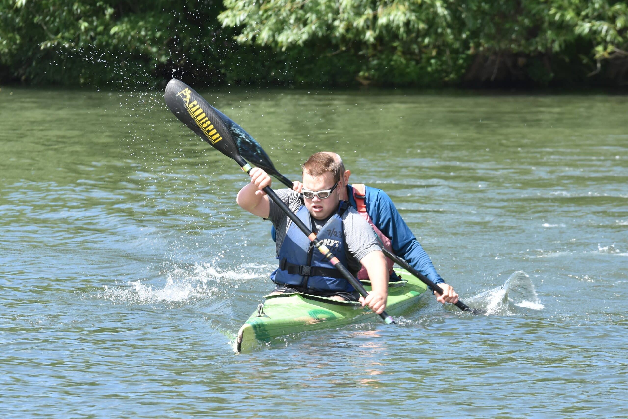 a child kayaking on the river