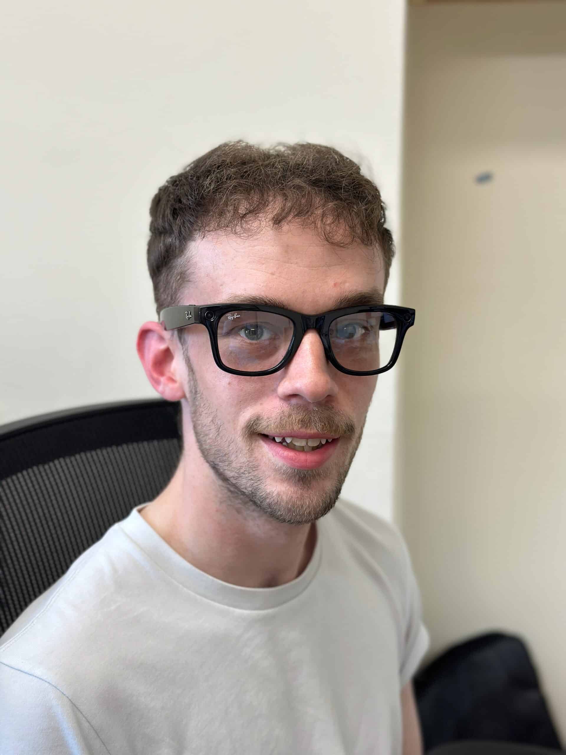 Jamie wearing the Meta smart glasses and smiling
